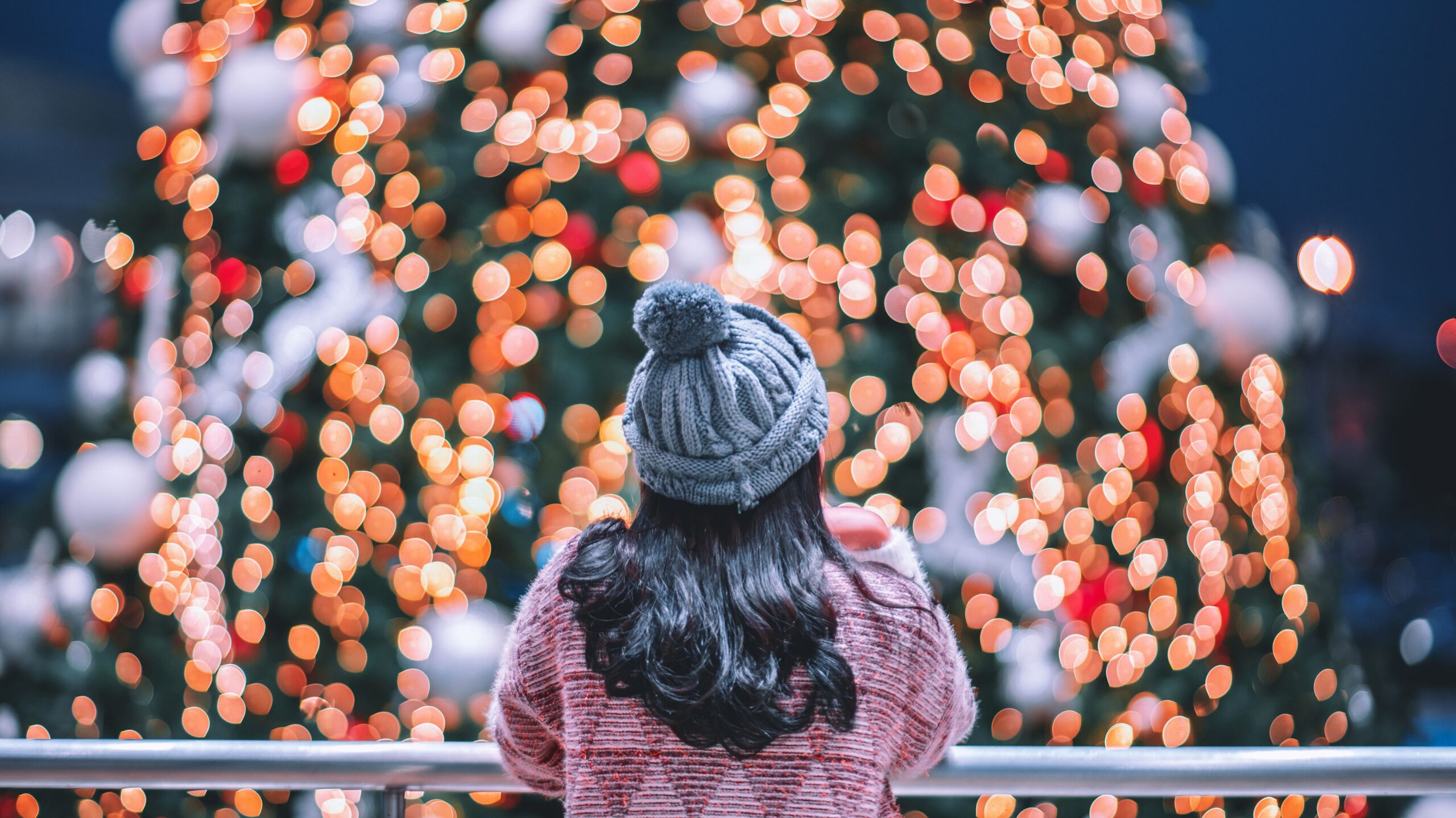 Girl looking at a Christmas tree