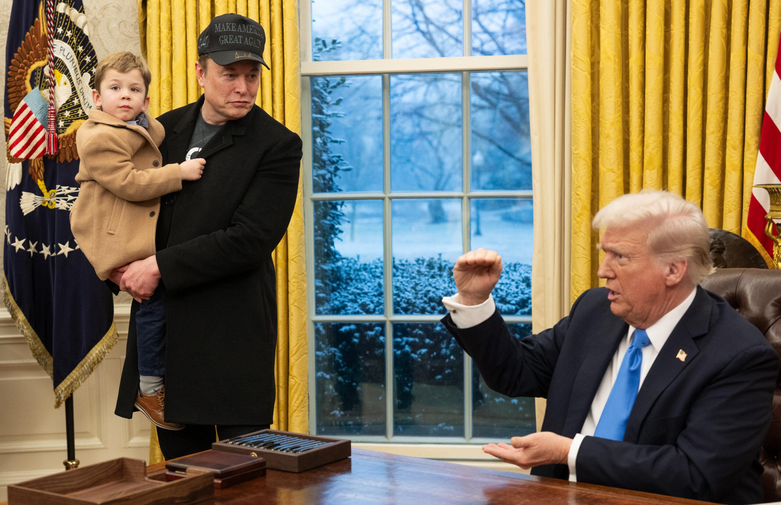 Elon (holding child) and Trump in Oval Office